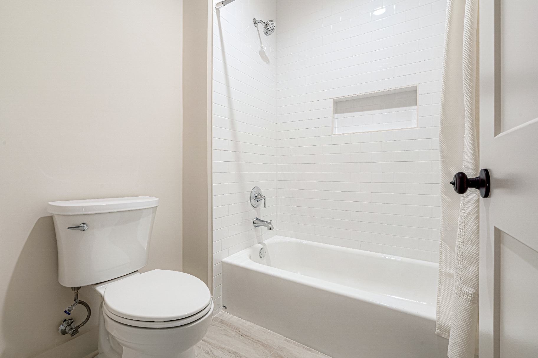 Secondary bath with white subway tile tub-shower combo