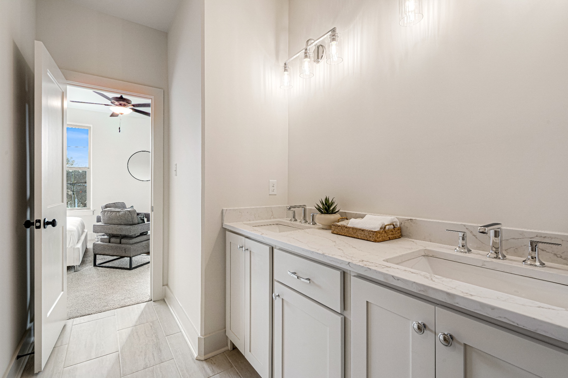 Jack-and-Jill bath with double quartz vanity and chrome fixtures