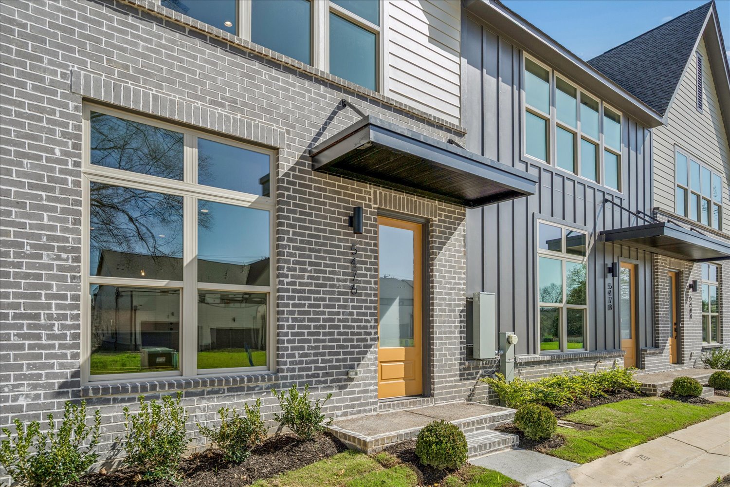 Townhome row with brick and board-and-batten façades
